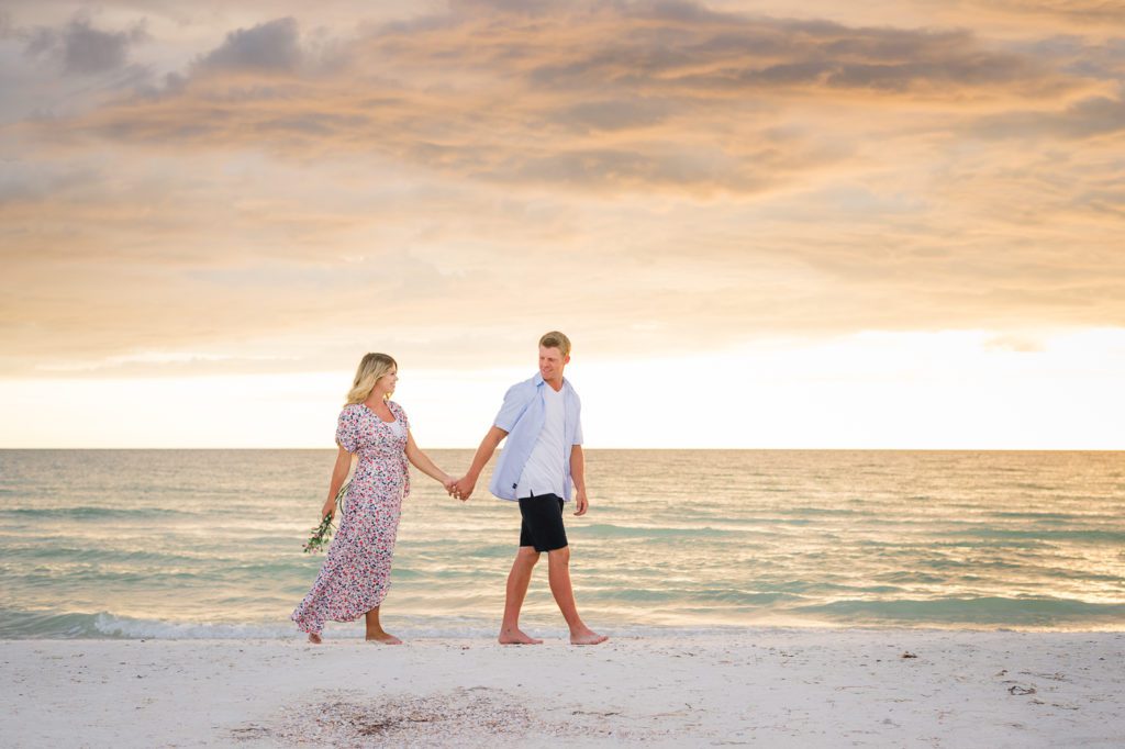 Clearwater Beach Photographer Engagement pictures blond walking on beach